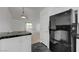 Bright and airy kitchen boasts stainless steel fridge, black countertops, and eat in counter at 10525 Pine Glen Ave # 206, Las Vegas, NV 89144