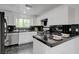 Stylish kitchen with black tile countertops, stainless steel dishwasher, and white cabinets at 10525 Pine Glen Ave # 206, Las Vegas, NV 89144