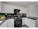 Modern kitchen featuring white cabinets, stainless steel oven, and sleek black tile backsplash at 10525 Pine Glen Ave # 206, Las Vegas, NV 89144