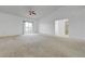 Spacious living room with sliding glass doors and fan at 10525 Pine Glen Ave # 206, Las Vegas, NV 89144