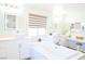 Bright bathroom featuring a modern soaking tub, dual vanities, makeup station and elegant fixtures at 10591 Haywood Dr, Las Vegas, NV 89135