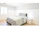 Bedroom with a patterned bedspread, neutral walls, and light wood floors at 10591 Haywood Dr, Las Vegas, NV 89135