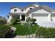 Charming two-story home featuring a well-manicured lawn and attached two-car garage at 10591 Haywood Dr, Las Vegas, NV 89135