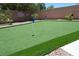 Backyard putting green with artificial turf and flag markers at 10591 Haywood Dr, Las Vegas, NV 89135