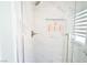 Elegant walk-in shower featuring marble tile, a built-in niche, and glass doors at 10591 Haywood Dr, Las Vegas, NV 89135