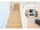 Elegant staircase leading to the upper level, showcasing hardwood steps and a bright, open design at 10591 Haywood Dr, Las Vegas, NV 89135