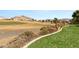 Backyard showcasing desert landscaping with golf course and mountain views at 10712 Back Plains Dr, Las Vegas, NV 89134