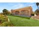 View of a lovely backyard with green grass and a covered patio area at 10712 Back Plains Dr, Las Vegas, NV 89134