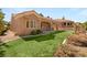 View of the rear of the house showcasing a covered patio and artificial turf at 10712 Back Plains Dr, Las Vegas, NV 89134