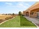 Backyard featuring artificial turf, a covered patio, and golf course views at 10712 Back Plains Dr, Las Vegas, NV 89134