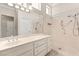 Bright bathroom featuring a walk-in shower with grab bars and a spacious vanity with ample counter space at 10712 Back Plains Dr, Las Vegas, NV 89134