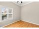 Bedroom featuring wood floors and a window with plantation shutters, offering lots of natural light at 10712 Back Plains Dr, Las Vegas, NV 89134
