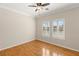 Bedroom featuring wood floors, a ceiling fan, and windows with plantation shutters at 10712 Back Plains Dr, Las Vegas, NV 89134