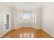 Bright bedroom featuring hardwood floors, a ceiling fan, and backyard access at 10712 Back Plains Dr, Las Vegas, NV 89134