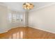 Bedroom features hardwood floors, a ceiling fan, and windows with shutters at 10712 Back Plains Dr, Las Vegas, NV 89134