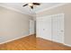 Bedroom featuring wood floors, a ceiling fan, and a closet with sliding doors at 10712 Back Plains Dr, Las Vegas, NV 89134