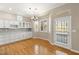 Dining room featuring hardwood floors, a chandelier, white cabinets, and backyard access at 10712 Back Plains Dr, Las Vegas, NV 89134