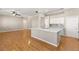Spacious kitchen showcasing a granite countertop island, stainless steel sink, and hardwood flooring at 10712 Back Plains Dr, Las Vegas, NV 89134