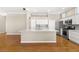 Bright kitchen featuring white cabinetry, granite countertops, stainless steel appliances, and hardwood floors at 10712 Back Plains Dr, Las Vegas, NV 89134