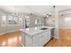 Open-concept kitchen boasting a granite countertop island, stainless steel sink, and hardwood floors at 10712 Back Plains Dr, Las Vegas, NV 89134