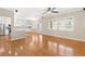 Open-concept living area with hardwood floors, large windows, and a view into the kitchen at 10712 Back Plains Dr, Las Vegas, NV 89134