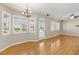 Living room featuring hardwood floors, several windows, and backyard access at 10712 Back Plains Dr, Las Vegas, NV 89134