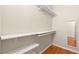 Spacious walk-in closet with wooden floors and built-in shelving, offering ample storage space at 10712 Back Plains Dr, Las Vegas, NV 89134