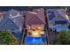 Stunning aerial view of home featuring a sparkling pool and outdoor living space at twilight at 10902 Fintry Hills St, Las Vegas, NV 89141
