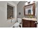 Stylish powder room featuring granite counters, custom stone accents, and modern fixtures at 10902 Fintry Hills St, Las Vegas, NV 89141