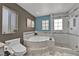 Modern bathroom featuring a soaking tub, shower, and a private window at 10902 Fintry Hills St, Las Vegas, NV 89141
