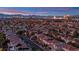 Expansive city view, showing rooftops, palm trees, and the Las Vegas skyline on the horizon at dusk at 10902 Fintry Hills St, Las Vegas, NV 89141