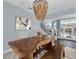 Elegant dining area with a large wood table, stylish chairs, and contemporary lighting at 10902 Fintry Hills St, Las Vegas, NV 89141
