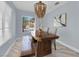 Charming dining room featuring a unique wooden table, bench, and a modern light fixture at 10902 Fintry Hills St, Las Vegas, NV 89141
