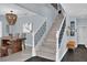 Inviting entryway showcases dining area and staircase with modern black iron railing and natural wood steps at 10902 Fintry Hills St, Las Vegas, NV 89141