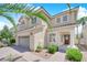 Beautiful two-story home with mature landscaping, a two-car garage, and a covered front porch at 10902 Fintry Hills St, Las Vegas, NV 89141