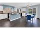 Modern kitchen with stainless steel appliances, a breakfast bar, and access to the outdoor pool area at 10902 Fintry Hills St, Las Vegas, NV 89141