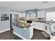 Bright kitchen featuring a center island with seating, stainless steel appliances, and ample counter space at 10902 Fintry Hills St, Las Vegas, NV 89141