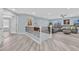 Bright living area boasts wood-look floors, lots of windows, and a comfortable gray couch at 10902 Fintry Hills St, Las Vegas, NV 89141