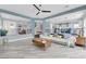 Open-concept living room boasts modern flooring, stylish furniture, and access to other areas of the home at 10902 Fintry Hills St, Las Vegas, NV 89141