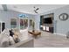 Cozy living room offering access to an outdoor pool area, plush seating, and stylish decor at 10902 Fintry Hills St, Las Vegas, NV 89141