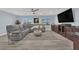 Comfortable living area with large grey sectional sofa, ceiling fan, and built in wet bar at 10902 Fintry Hills St, Las Vegas, NV 89141