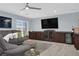 Relaxing living room featuring a modern wet bar, comfortable grey seating and large TV at 10902 Fintry Hills St, Las Vegas, NV 89141
