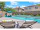 Inviting pool area with relaxing lounge chairs and a beautiful waterfall feature at 10902 Fintry Hills St, Las Vegas, NV 89141
