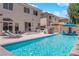 Large, sparkling pool with custom outdoor kitchen, an outdoor bar, and mature shade trees at 10902 Fintry Hills St, Las Vegas, NV 89141
