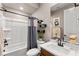 Cozy bathroom with a shower-tub combo, modern vanity, and decorative accents at 12430 Foxtail Run Ave, Las Vegas, NV 89138