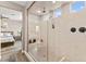 Elegant bathroom with glass shower and modern fixtures, leading to the bedroom at 12430 Foxtail Run Ave, Las Vegas, NV 89138