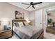 Bedroom featuring a wooden bed frame, modern decor, and a ceiling fan at 12430 Foxtail Run Ave, Las Vegas, NV 89138