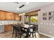 Dining area with a wooden table, seating for six, and views of the outdoor patio and backyard at 12430 Foxtail Run Ave, Las Vegas, NV 89138