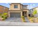 Charming two-story home with a well-manicured front yard and a gray driveway at 12430 Foxtail Run Ave, Las Vegas, NV 89138