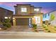 Charming two-story home with a modern garage door, well-maintained landscaping, and inviting curb appeal at 12430 Foxtail Run Ave, Las Vegas, NV 89138